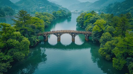 Fototapeta premium Drone perspective of the Kintai Bridge arching over the Nishiki River in Iwakuni