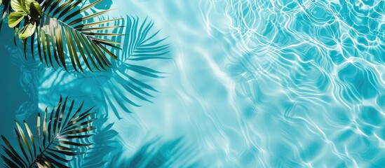 Pool edge and water with exotic summer vibes. Minimal vacation idea captured in a flat lay, top view composition with space for text.