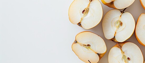 A close-up photo of sliced Aonashi Nijisseiki pear on a plain white backdrop with copy space image.