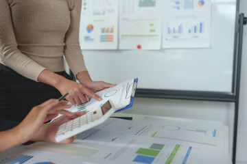 Team work process Team of business people searching for piles of papers and having a meeting Discuss business statistics, profits, financial growth rates in graph papers. financial data chart.