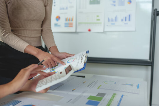 Team work process Team of business people searching for piles of papers and having a meeting Discuss business statistics, profits, financial growth rates in graph papers. financial data chart.