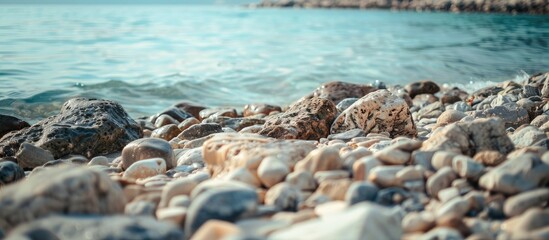 Obraz premium Rocky seashore texture with background blur and room for text in a copy space image.