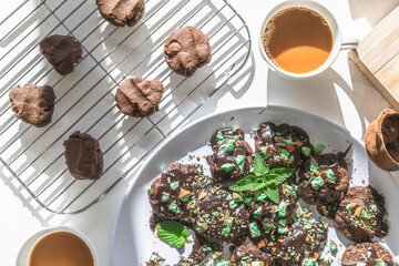 Homemade delicious double chocolate chip mint iced cookies, freshly baked at home with Mum and Daughter