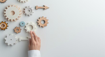 Wooden gears with arrows and a hand touching on a white background