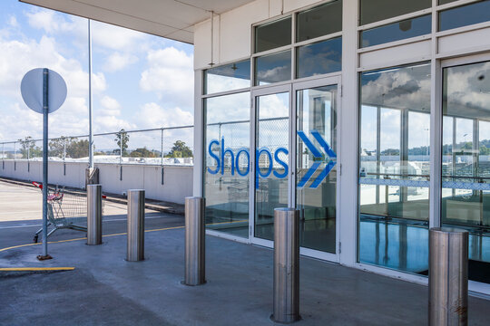Sign to shops from top carpark level with trolley left behind