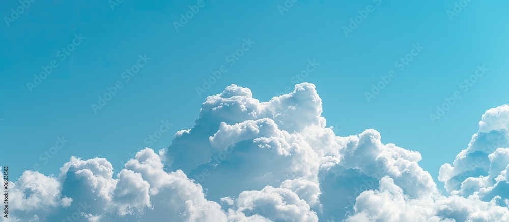 Poster Daytime view of clouds against a clear blue sky with copy space image available.