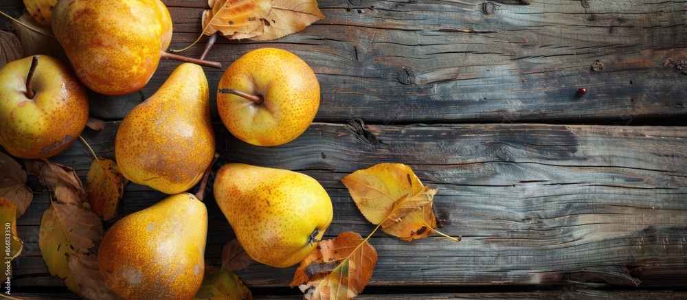 Poster autumnal scene with yellow pears arranged on a rustic wooden table, featuring copy space image.