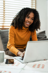 Businesswoman using laptop computer in home office. Happy woman, entrepreneur, small business owner working online.