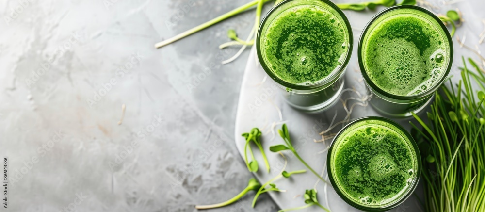Poster a marble table showcasing glasses of wheatgrass juice with green sprouts, offering ample room for te