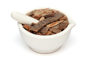 Close-up of Dry Organic Banyan or Banian (Ficus benghalensis) tree barks, in white ceramic mortar and pestle, isolated on a white background.