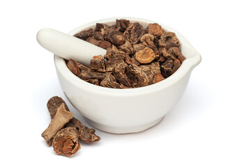 Close-up of Dry Organic Red Sage or Behman Lal (Salvia Haematodes) herb, in white ceramic mortar and pestle, isolated on a white background.