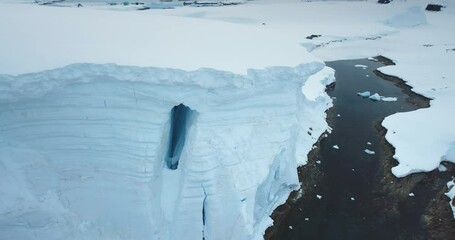 Aerial drone panorama glacier canyon frozen ocean bay in Antarctica. Winter landscape wild nature. Glacier giant ice wall towering above rocky coast. Polar environment. Travel beautiful South Pole - Powered by Adobe