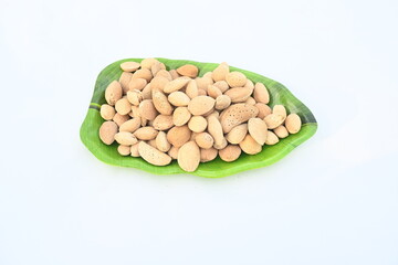 Almond with shell. It's other name Prunus amygdalus and Prunus dulcis. The almond is also the name of the edible and widely cultivated seed of this tree. indian almond.