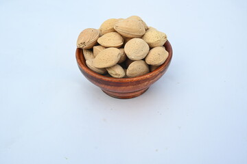 Almond with shell. It's other name Prunus amygdalus and Prunus dulcis. The almond is also the name of the edible and widely cultivated seed of this tree. indian almond.