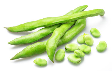 Green broad bean pod and several broad beans isolated on white background.