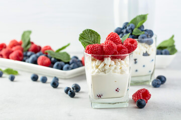 Cottage cheese with cream, raspberries, and blueberries.