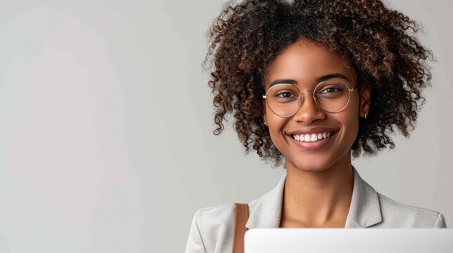 a joyful entrepreneur holding a laptop, smiling confidently on a white background, showcasing the innovation and drive in business, with ample copy space for text