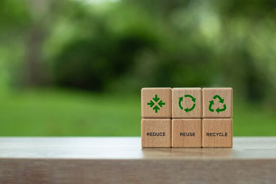 Reduce, reuse, recycle symbol on wooden blocks. Ecological concept. An ecological metaphor for ecological waste management and a sustainable and economical lifestyle. Recycling and sustainability.