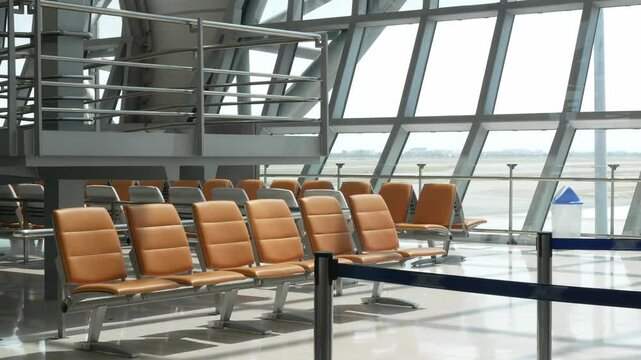 interior inside airport departure hall terminal at lounge waiting area with bench chair without any passenger people in airport departure terminal area