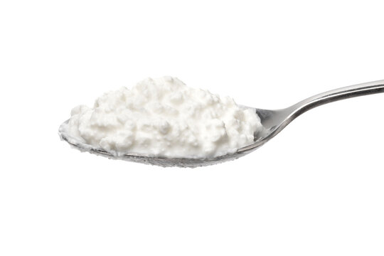 Metal spoon with cottage cheese on white background close up