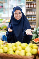Portrait of a positive contented woman in a veil in a supermarket