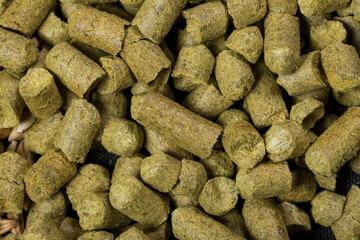Close up granulated hops. Ingredient for Industrial production of beer.