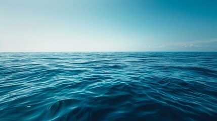Fototapeta premium Deep blue sea with a clear sky above and distant horizon, creating a serene and tranquil atmosphere