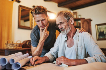 Senior engineer, apprentice and blueprint for project design, internship and learning in home office. Engineering, drawing and elderly dad with son for family business, entrepreneur and creativity