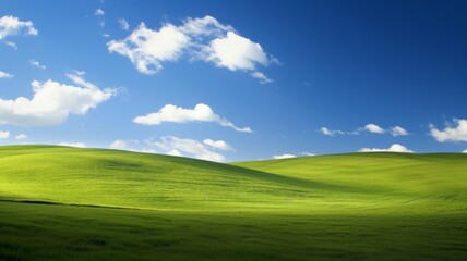 Idyllic Green Hills under Blue Sky with Fluffy White Clouds. Concept of nature, peace, serenity, and tranquility