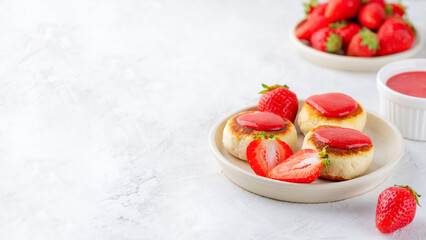 Vegan cheesecakes, syrniki, cheese pancakes with strawberries, jam, cashew and tofu on a table. Sugar, lactose and gluten free. Copy space.