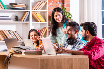 Indian asian four college or university students using laptop together