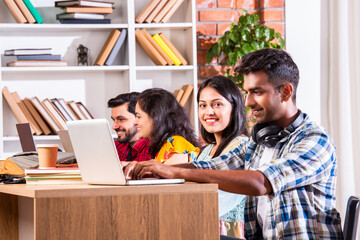 Indian asian four college or university students using laptop together
