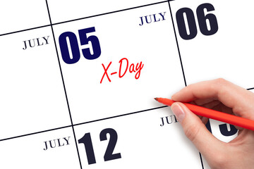 July 5. Hand writing text X-Day on calendar date. Save the date.