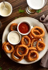 Fried breaded onion rings served with sauce