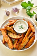 Oven baked potato wedges with sauce
