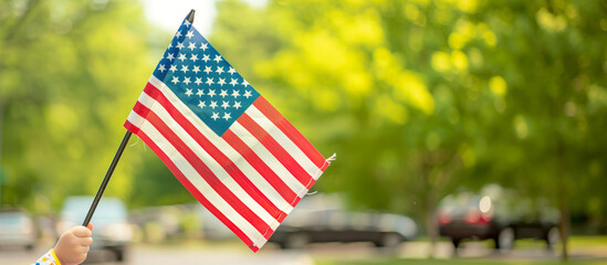 a detailed image of an American flag held by a child during a Fourth of July parade, American Flag, Patriotism, Flying, celebrations, Independence day, 4th july, with copy space