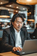 Portrait of a Japanese business traveler working on a laptop in the airport lounge, high quality photo, photorealistic, focused expression, studio lighting