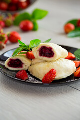 cooked sweet homemade steamed dumplings with strawberries