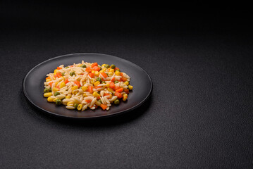 Delicious boiled rice with vegetables corn, carrots, peas with salt