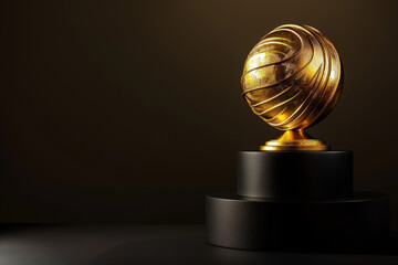 Golden award with sphere shape standing on black podium, celebrating excellence and achievement in music
