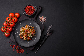 Spicy Asian dish with sliced meat fillet, hot pepper, carrots and sesame seeds