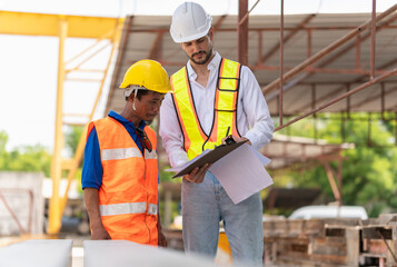 Engineer man and worker team inspect the construction site, Site manager and builder at a construction site.