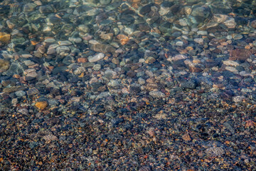 Texture of stone. Clear water on the sea. Rocky shore of the beach.
