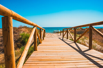 Wooden Pathway Leading to Beach on a Sunny Day