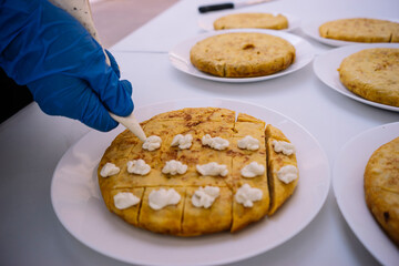Chef Decorating Traditional Spanish Tortilla with Aioli