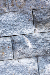 The image shows a detailed view of a brick wall with numerous stains