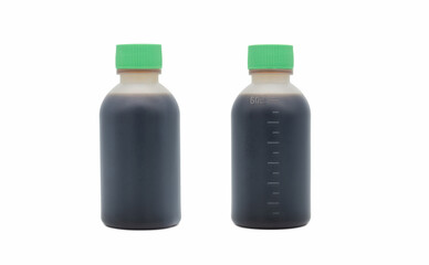 A set of small plastic bottles containing dark Chinese medicine close-up isolated on white background