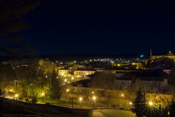 Fototapeta premium Night view of a small medieval village called Cifuentes with street lamps illuminating the streets.