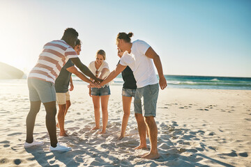Beach, stack and group with hands together, summer and travel with support, team building and nature. Friends, seaside and men with women, ocean and cooperation with holiday, getaway trip or vacation