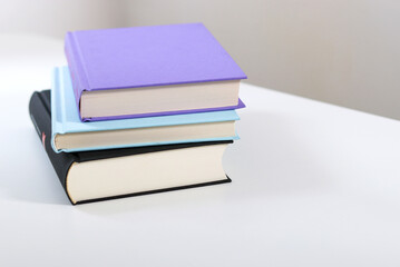 Close up mock up books stack on white table with copy space 